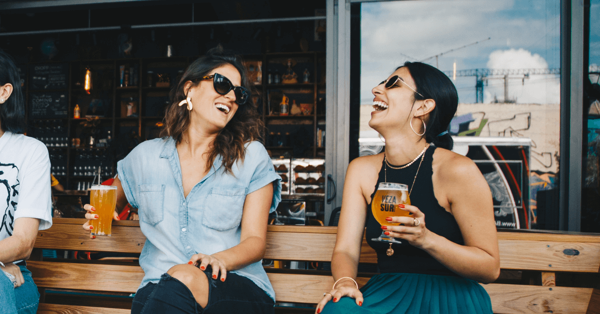 women drinking beer at pub